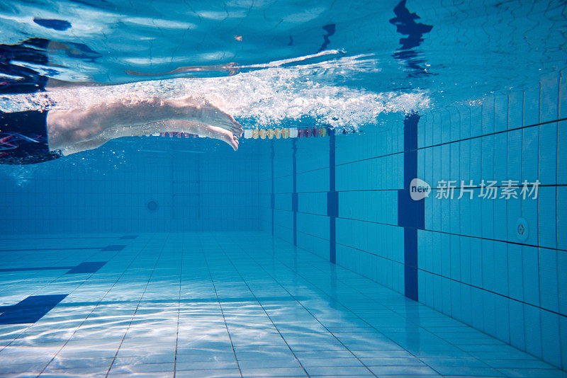 Male swimmer swimming underwater in a pool